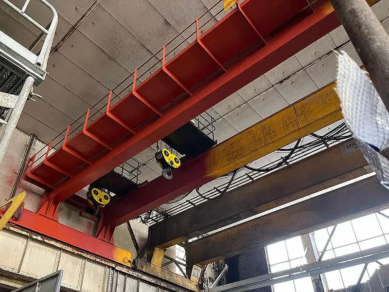 Protective coating being applied to overhead crane