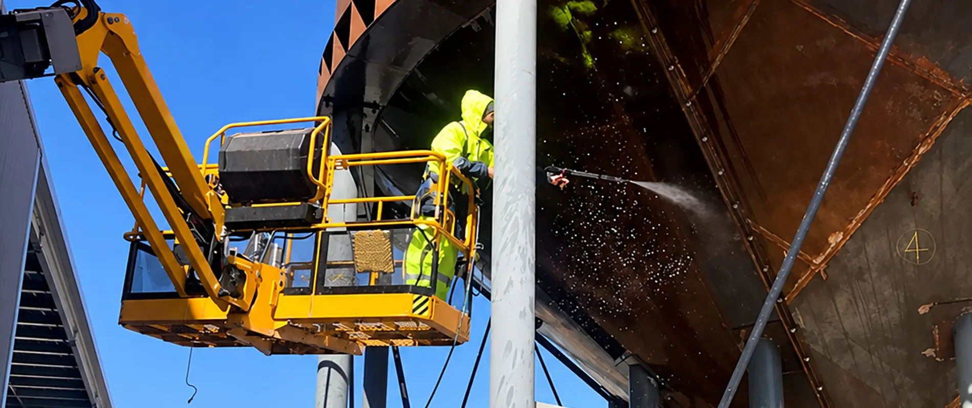 Water tank being pressure washed for NanoPrep application